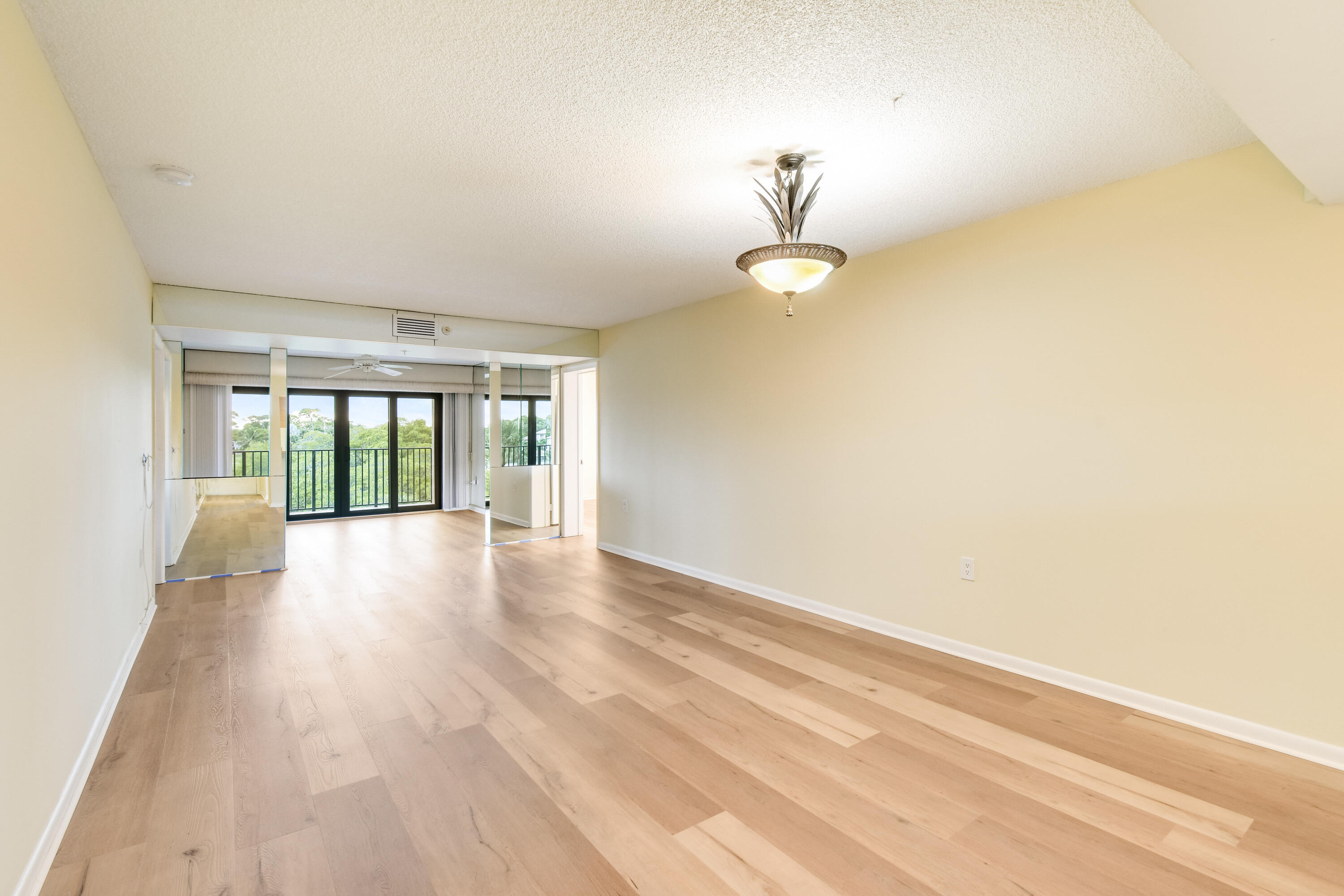 1701 Marina Isle Way, Unit 301 Jupiter, FL 33477 - Photo 12 of 60 wooden floor in an empty room with a window