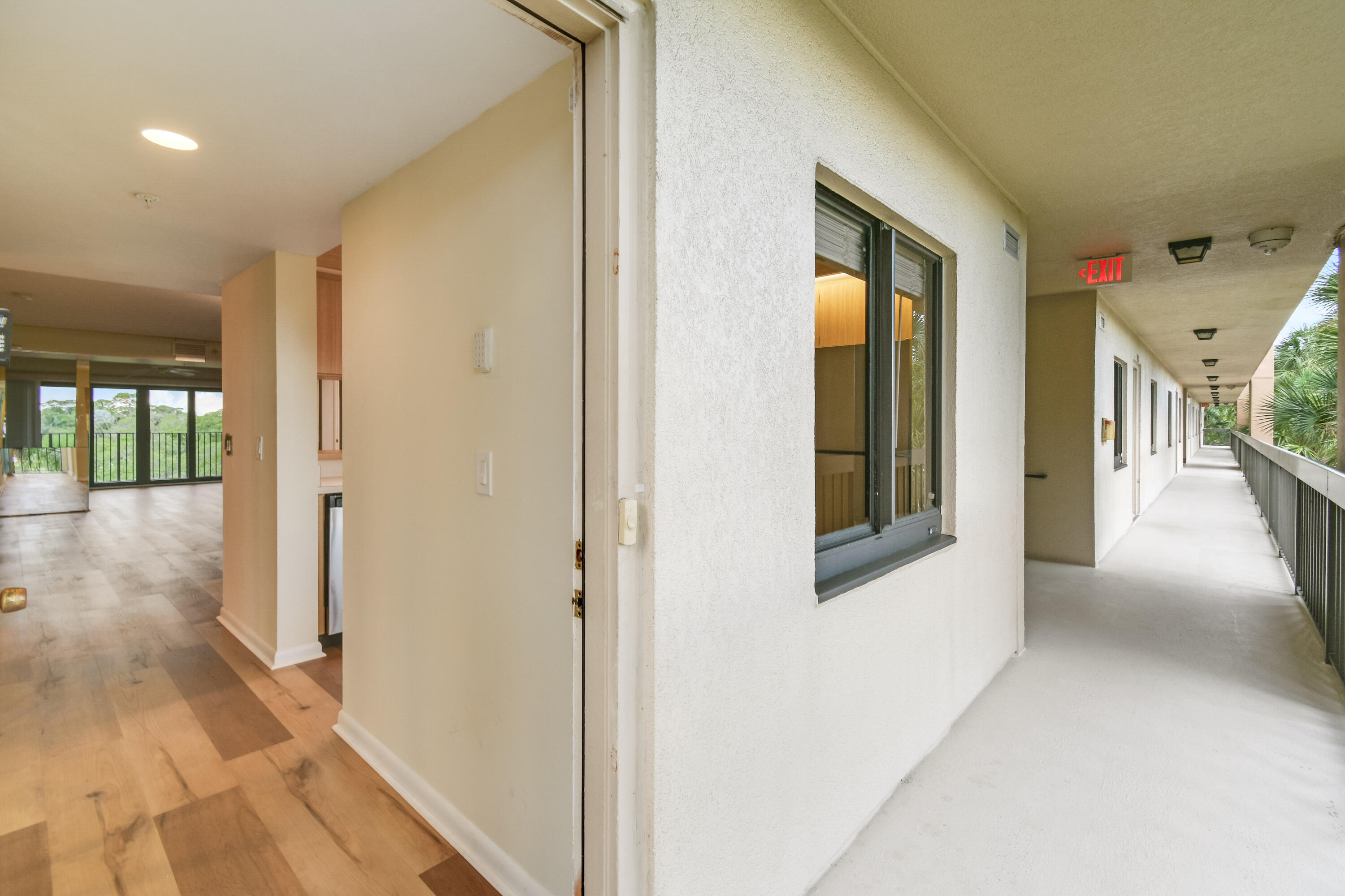 1701 Marina Isle Way, Unit 301 Jupiter, FL 33477 - Photo 13 of 60 a view of a hallway with wooden floor and windows