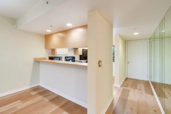 a view of a room with wooden floor and window