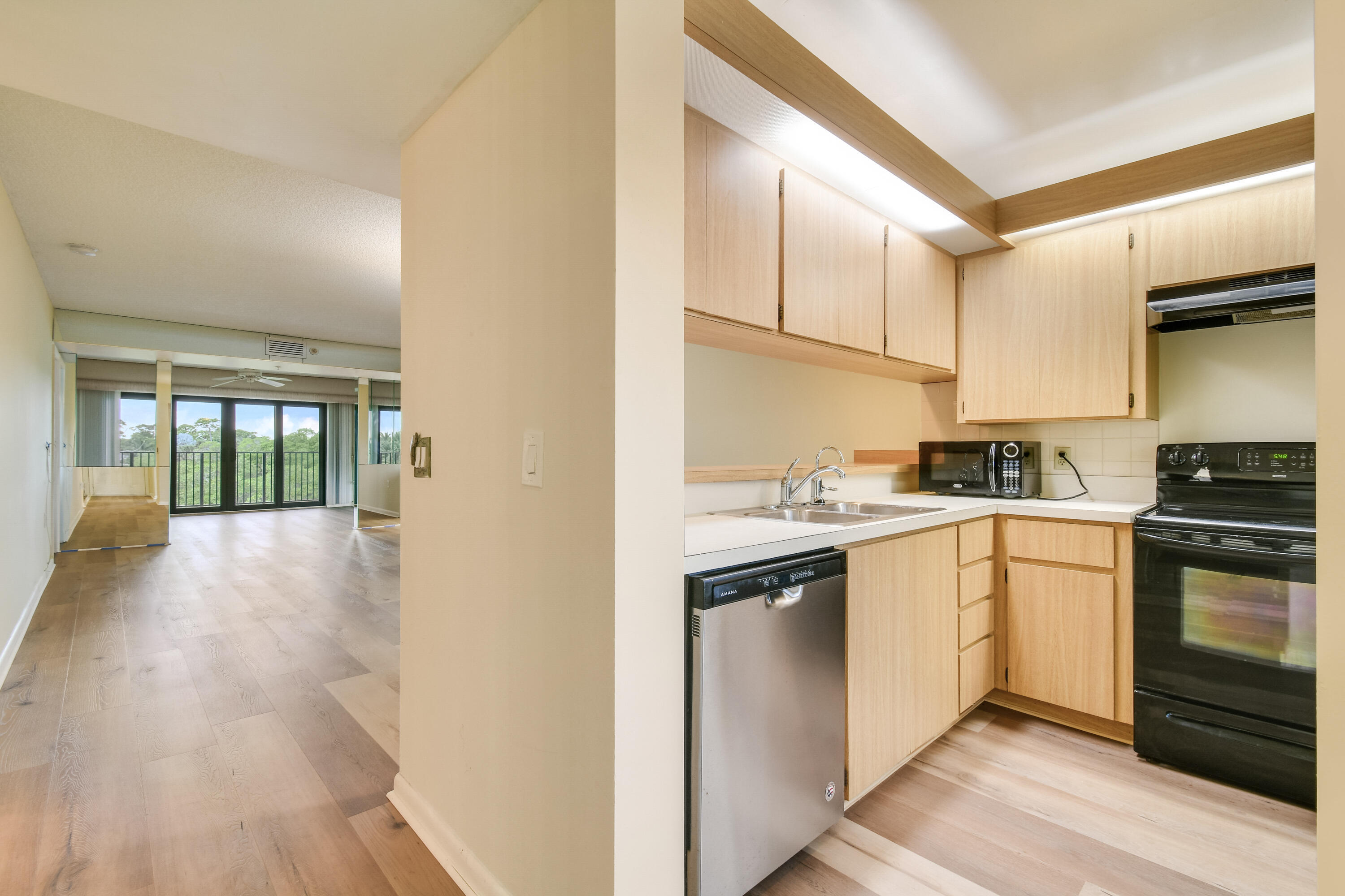 1701 Marina Isle Way, Unit 301 Jupiter, FL 33477 - Photo 19 of 60 a kitchen with granite countertop white cabinets and white appliances