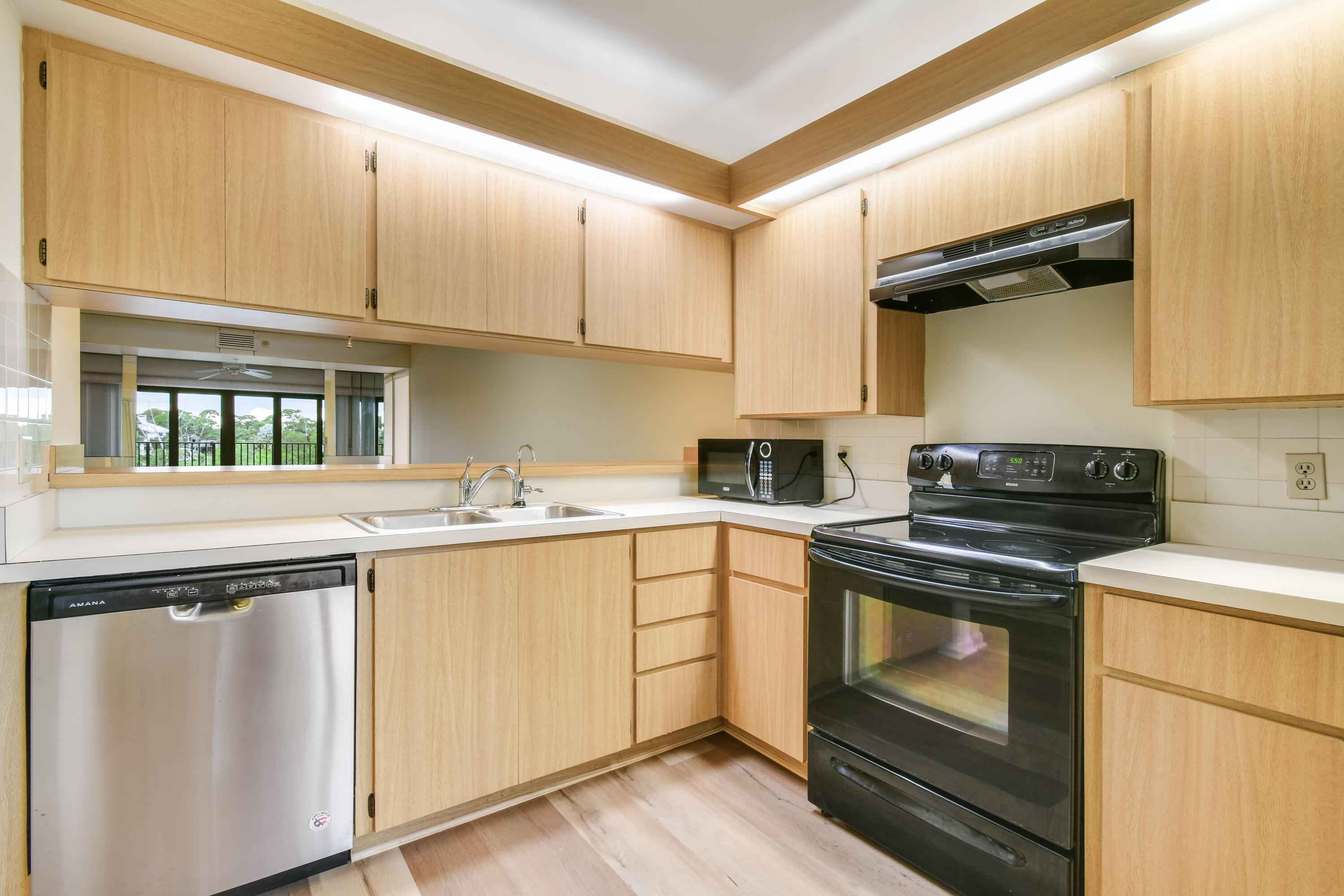 1701 Marina Isle Way, Unit 301 Jupiter, FL 33477 - Photo 21 of 60 a kitchen with cabinets appliances and a sink