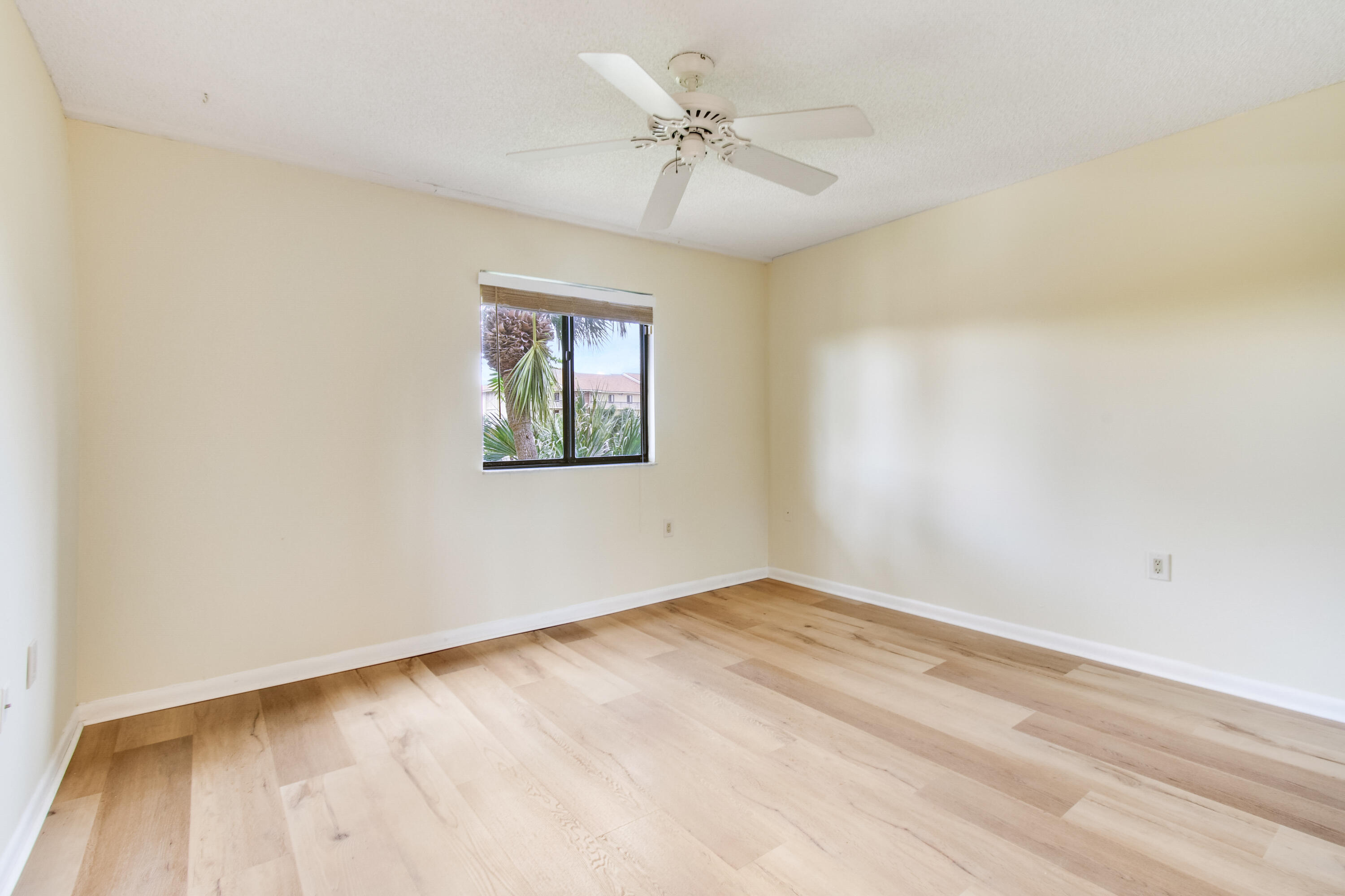 1701 Marina Isle Way, Unit 301 Jupiter, FL 33477 - Photo 35 of 60 an empty room with a window and a ceiling fan