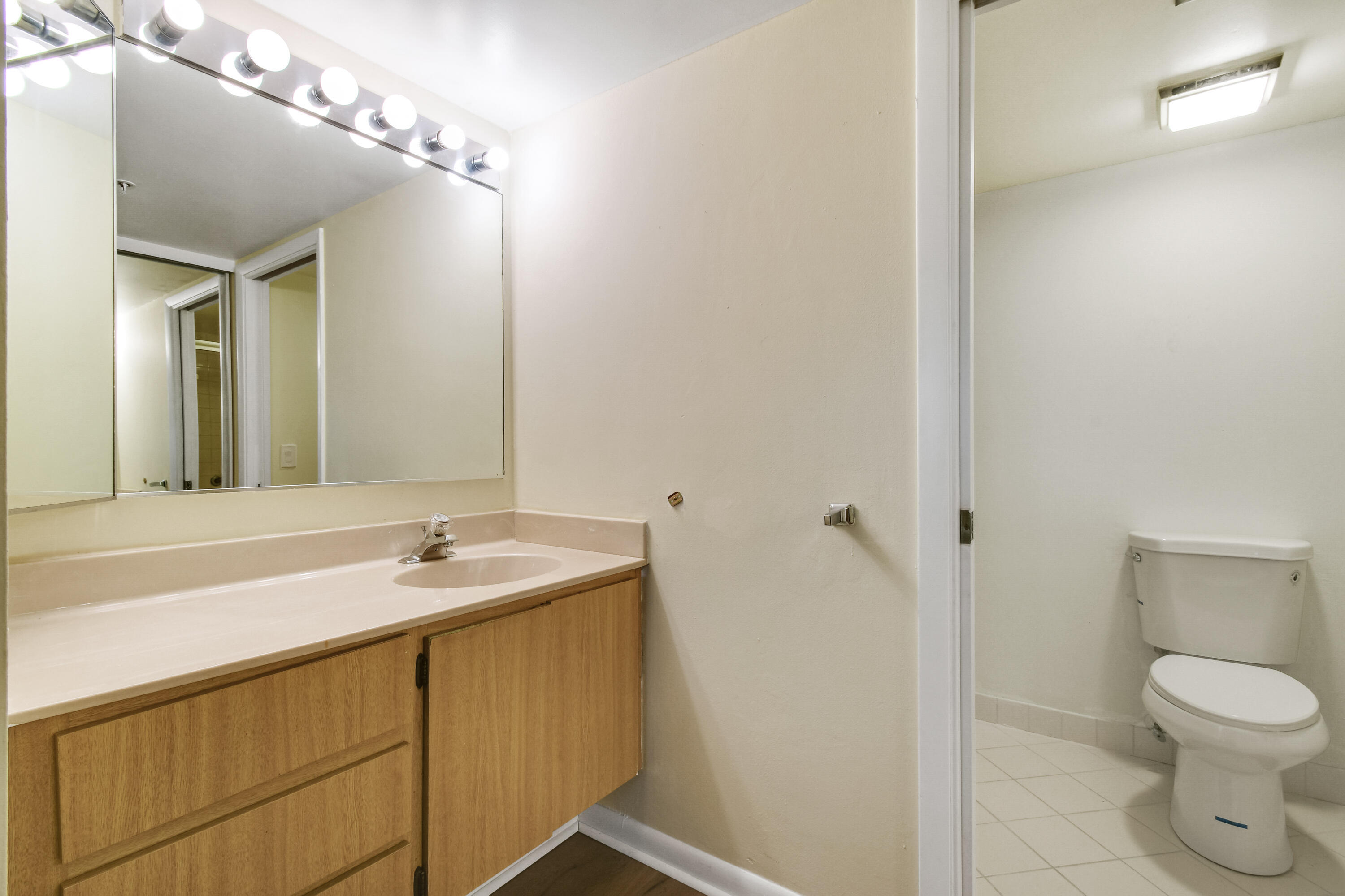 1701 Marina Isle Way, Unit 301 Jupiter, FL 33477 - Photo 39 of 60 a bathroom with a sink and a mirror