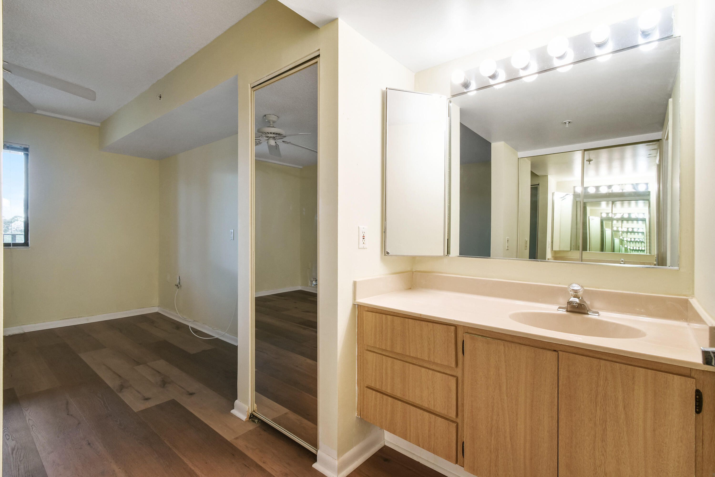 1701 Marina Isle Way, Unit 301 Jupiter, FL 33477 - Photo 40 of 60 a bathroom with a sink and a mirror
