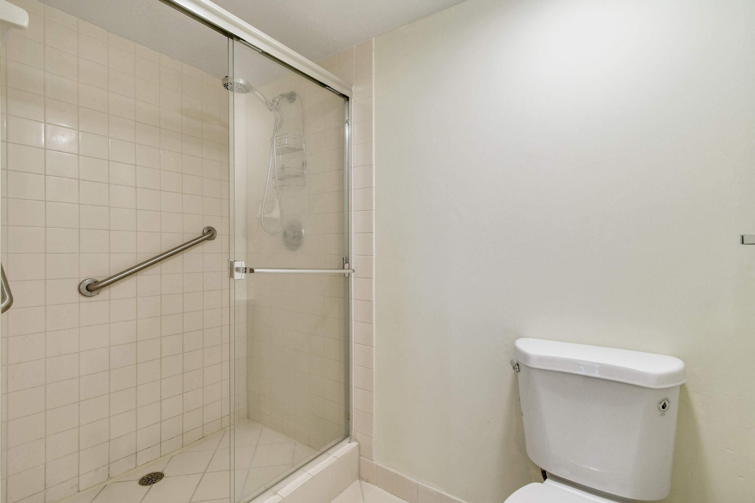 1701 Marina Isle Way, Unit 301 Jupiter, FL 33477 - Photo 41 of 60 a bathroom with a shower and toilet