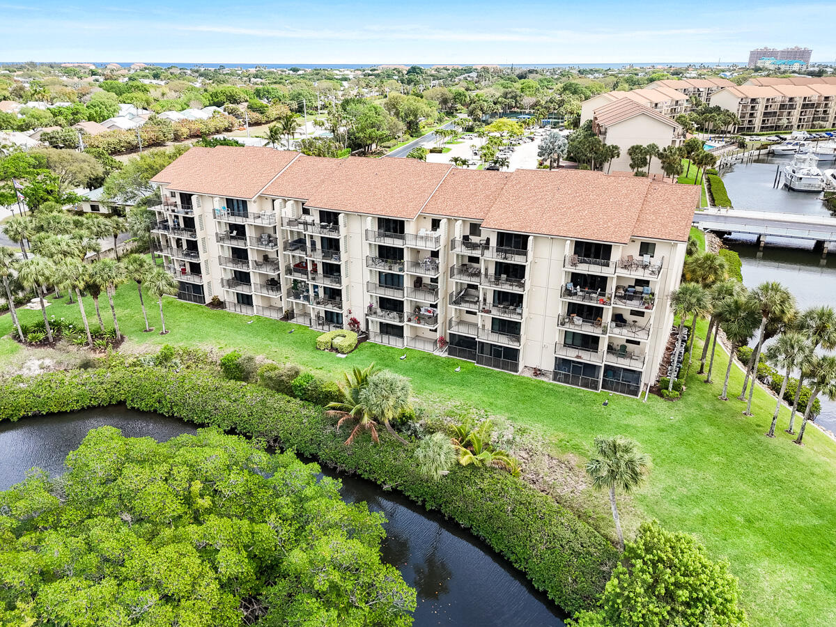 1701 Marina Isle Way, Unit 301 Jupiter, FL 33477 - Photo 55 of 60 a view of a large building with a yard