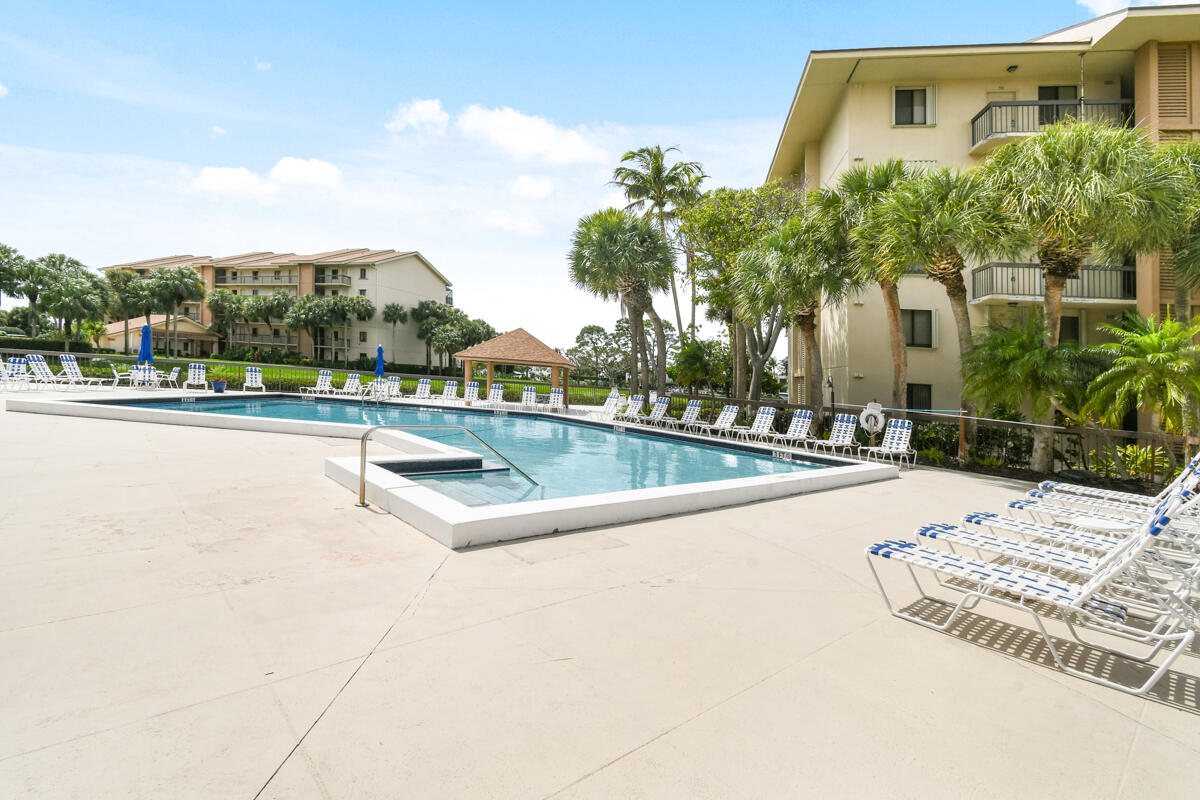 1701 Marina Isle Way, Unit 301 Jupiter, FL 33477 - Photo 58 of 60 a view of a swimming pool with a patio
