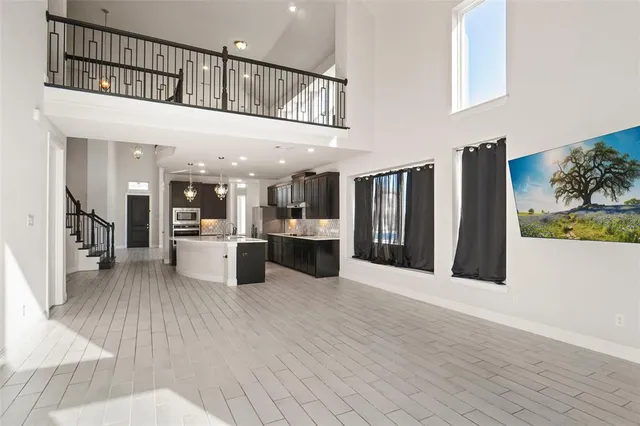 a open kitchen with white cabinets and stainless steel appliances