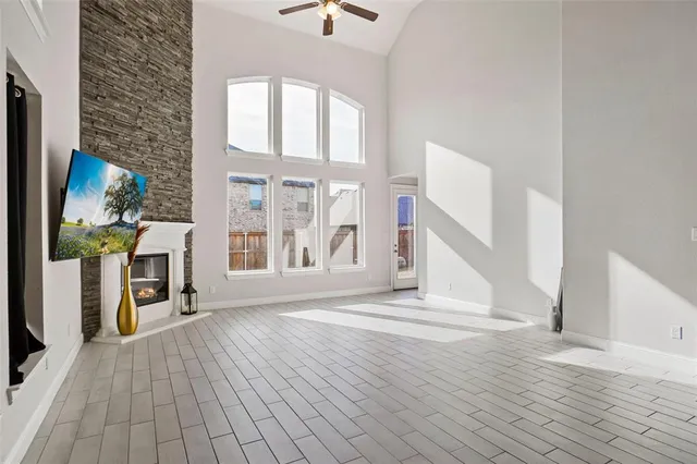 a view of a livingroom with wooden floor and a large window