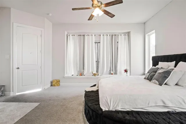 a bedroom with a bed and window