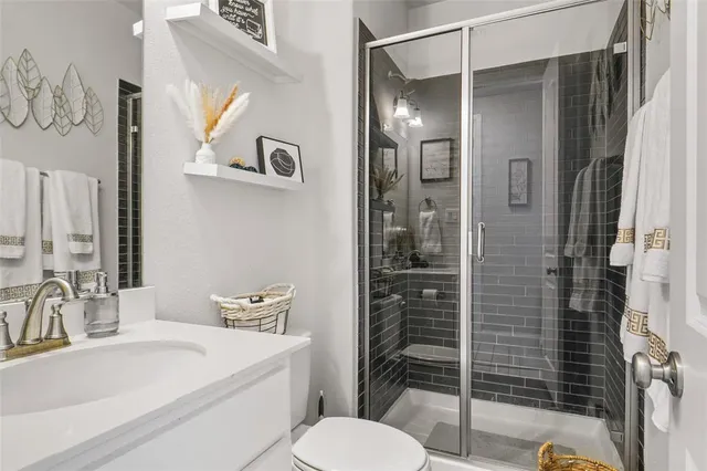 a bathroom with a sink toilet and shower