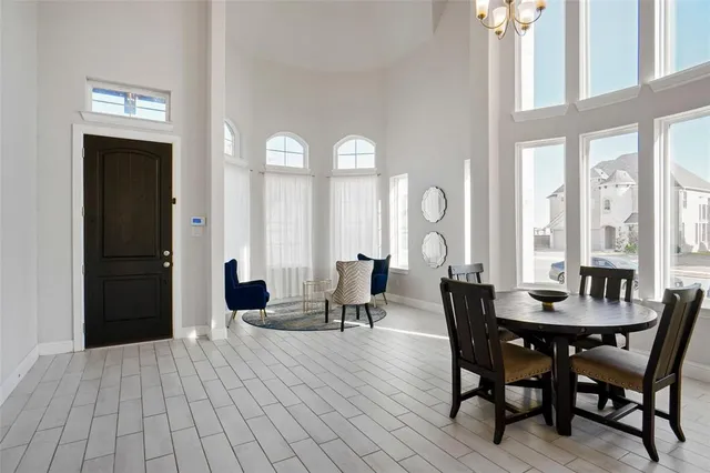 a view of a dining room with furniture and chandelier