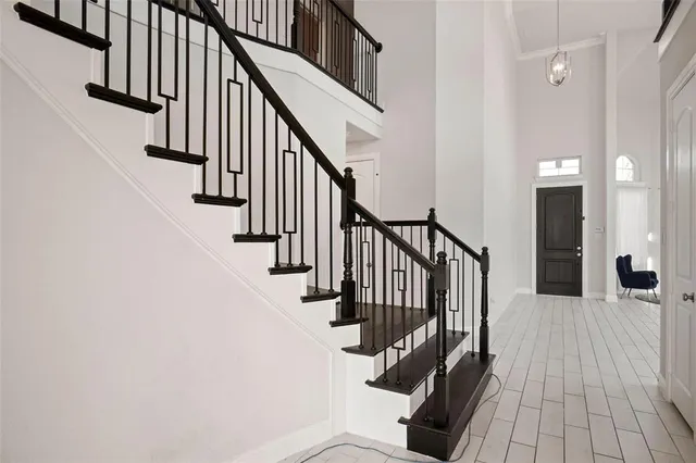 a view of staircase with wooden floor and a rug