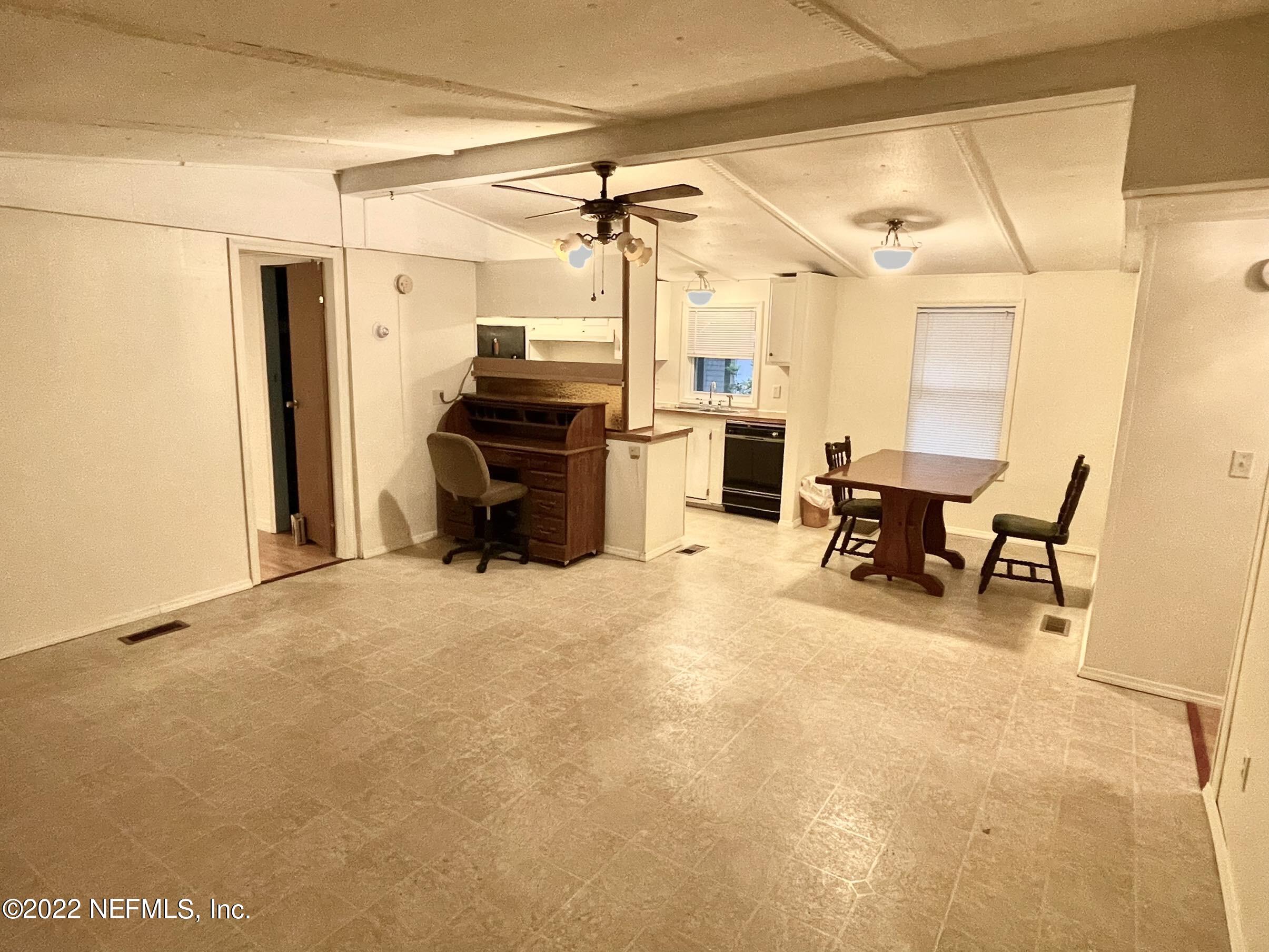 121 Crows Bluff Road Satsuma, FL 32189 - Photo 7 of 14 a view of a livingroom with furniture and a refrigerator