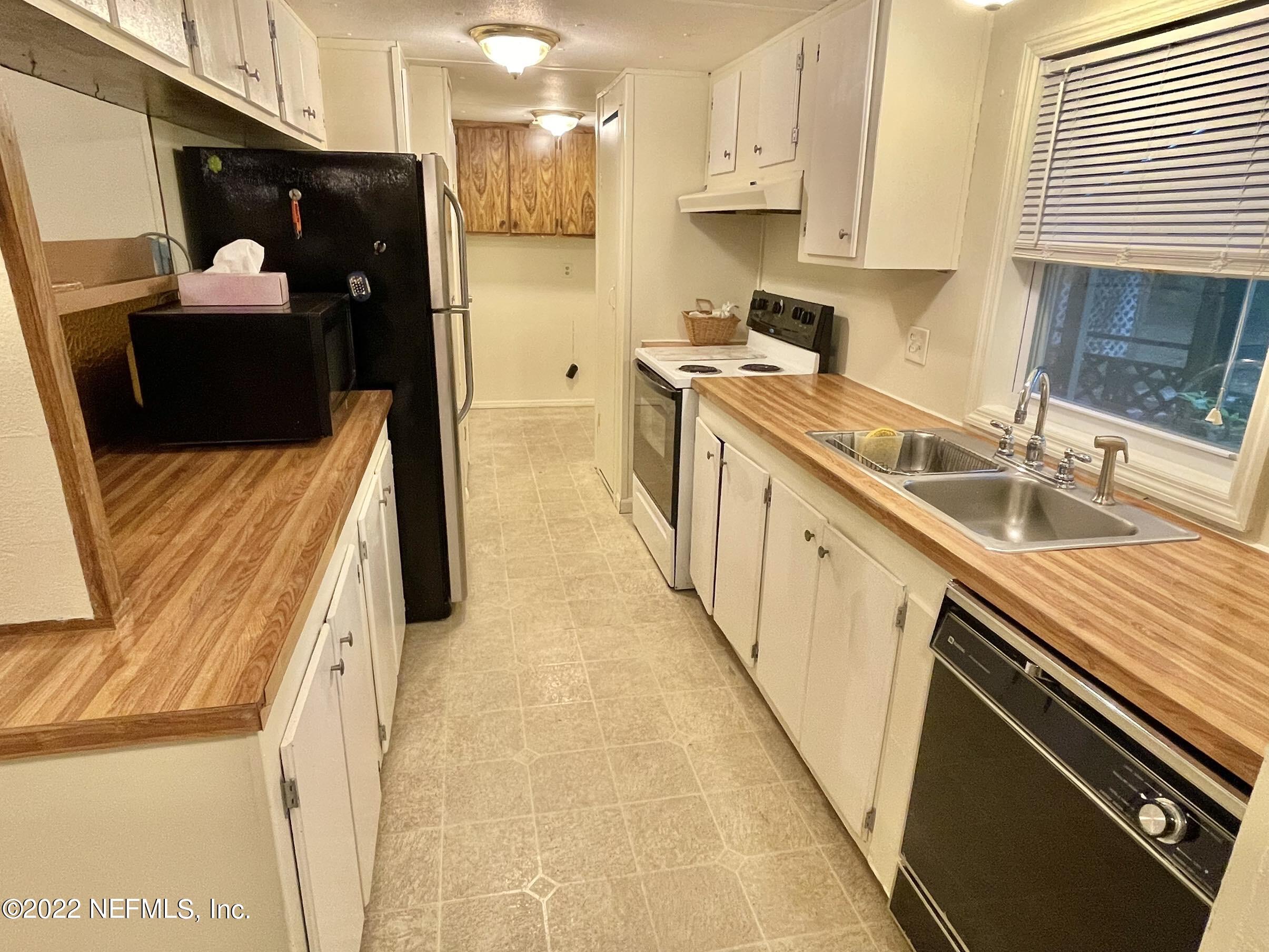 121 Crows Bluff Road Satsuma, FL 32189 - Photo 8 of 14 a kitchen with a sink and wooden floor