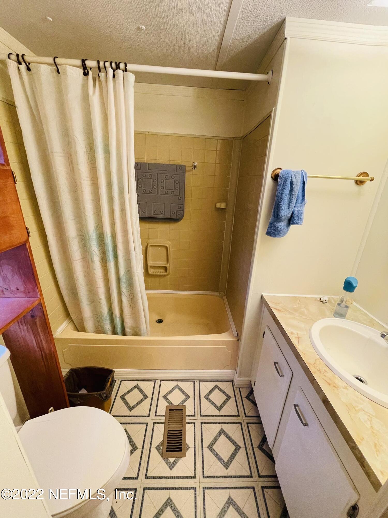 121 Crows Bluff Road Satsuma, FL 32189 - Photo 10 of 14 a bathroom with a granite countertop sink and a mirror