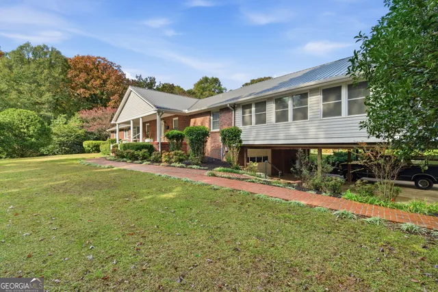 a front view of a house with a yard and porch