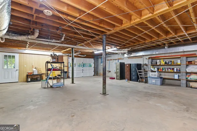 a view of yard from deck with patio