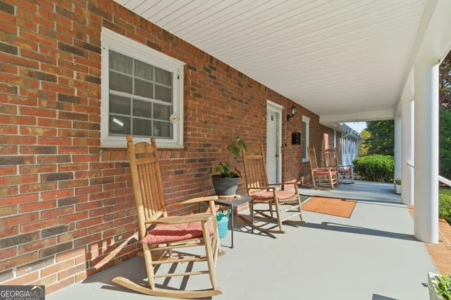 a living room with fireplace furniture and a rug
