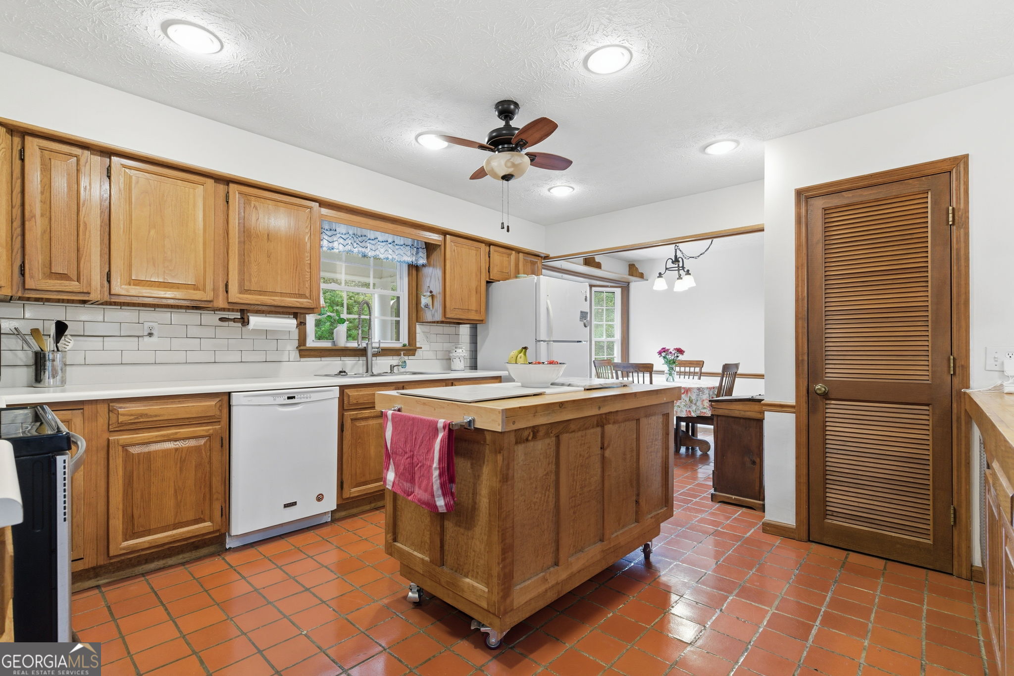 91 Almond Road LaGrange, GA 30241 - Photo 33 of 46 a kitchen with stainless steel appliances granite countertop a stove a sink dishwasher and a refrigerator