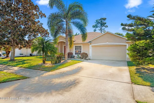 a view of a house with a yard and a garage