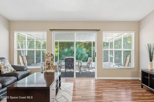 a living room with furniture and large windows