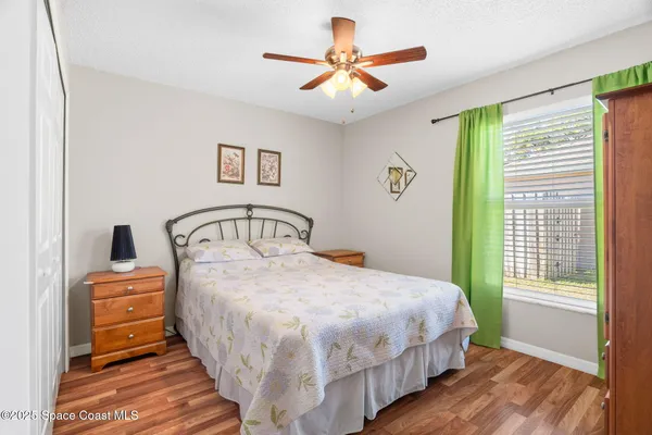 a bedroom with a bed and a large window