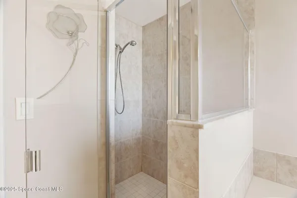 a bathroom with a glass shower door