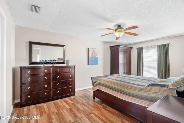 a bedroom with a bed a lamp and a dresser