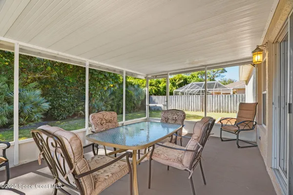 a patio with yard glass top table and chairs