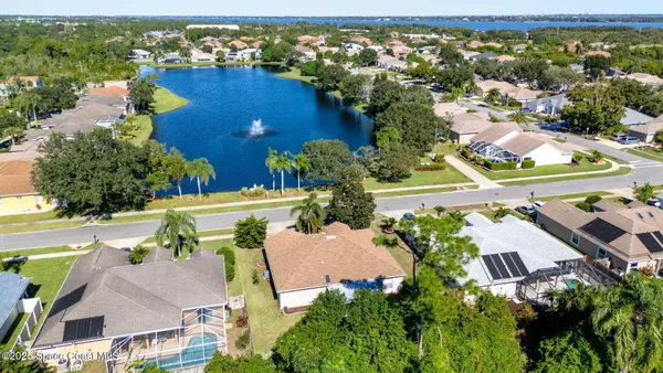 an aerial view of residential houses with outdoor space and swimming pool