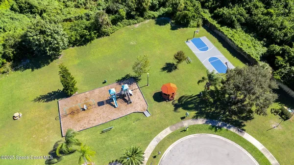 an aerial view of a house with a swimming pool