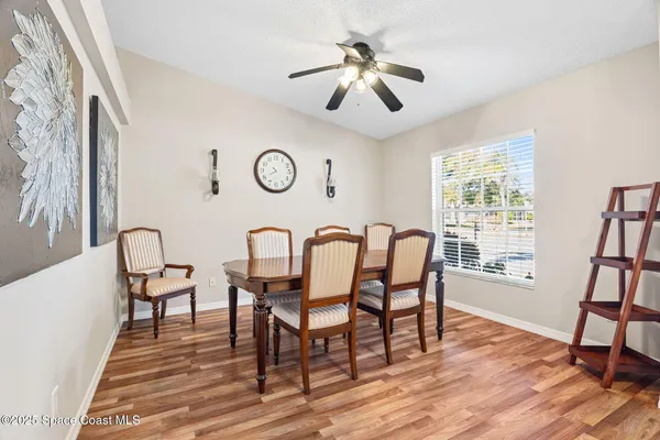 a view of a dining room with furniture window and wooden floor