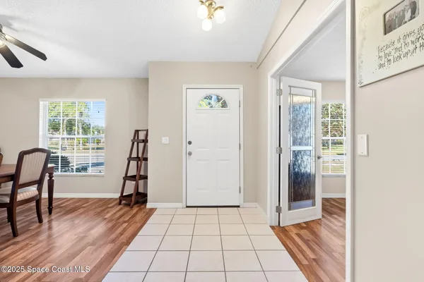 a view of a bedroom with furniture and windows