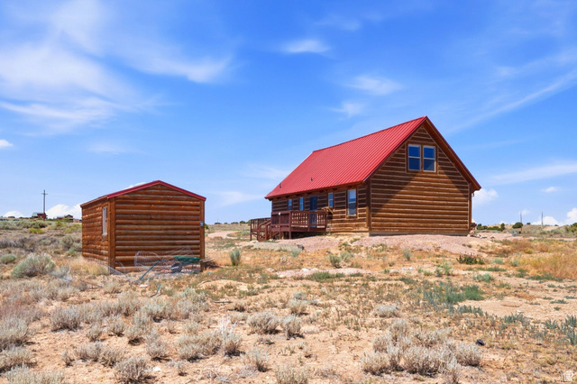 10937 South County Road, Unit 29 Duchesne, UT 84021 - Photo 31 of 41 Log cabin-style residence featuring a prominent red metal roof