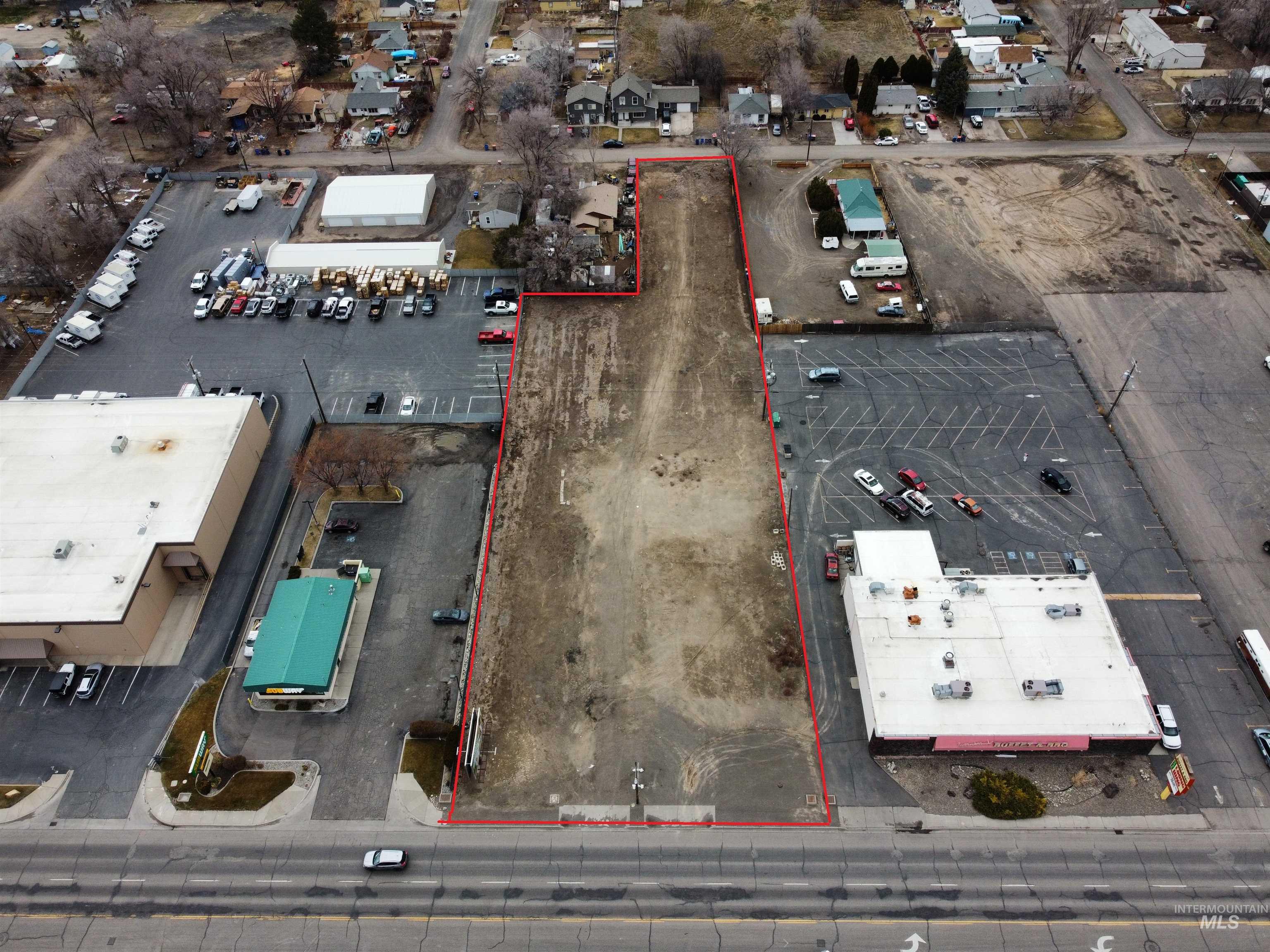 Aerial view of property and surrounding area featuring property parcel outlined