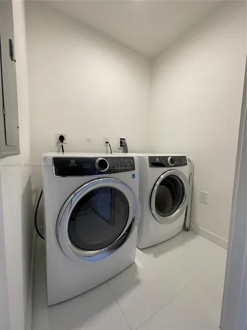a roof deck with couches and wooden floor