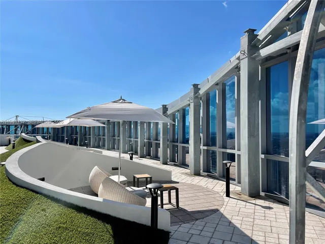 a view of backyard with outdoor seating and city view