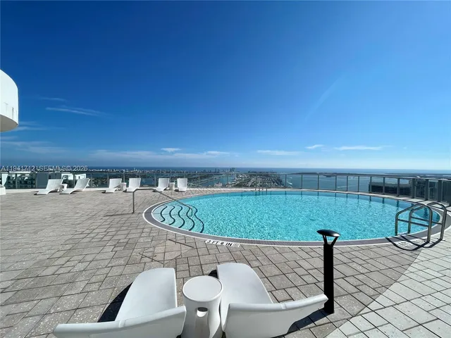 a view of a living room with a large window and chandelier