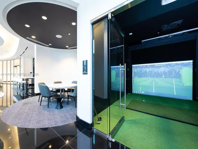 a living room with furniture large window and wooden floor