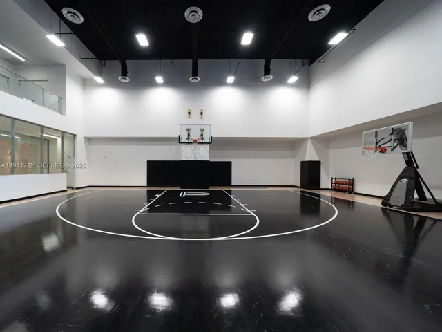 a living room with furniture and large windows