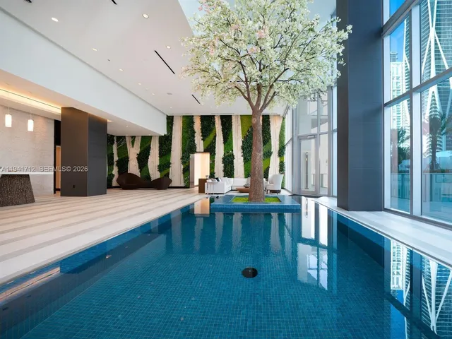 a living room with furniture and painting on the wall