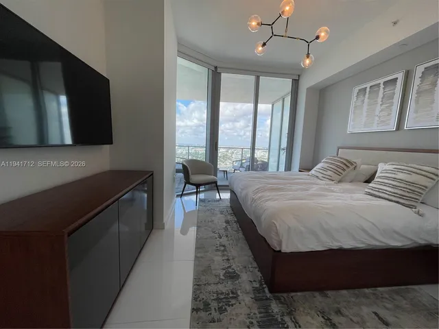 a bedroom with a bed and a television