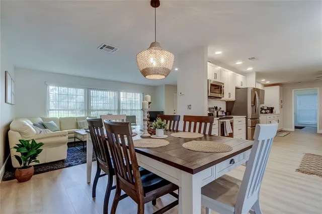 a kitchen with stainless steel appliances white cabinets and a potted plant