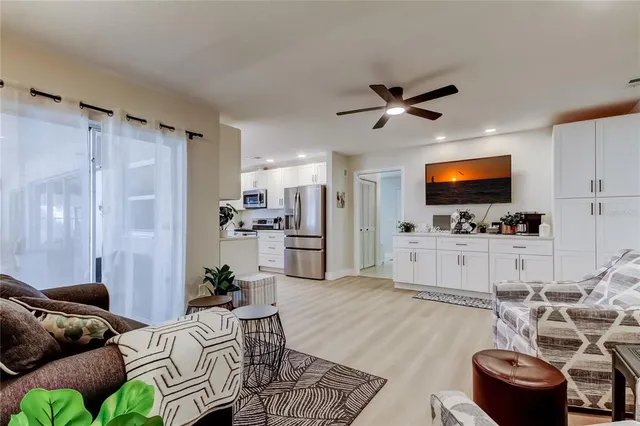 a bedroom with a bed and a ceiling fan