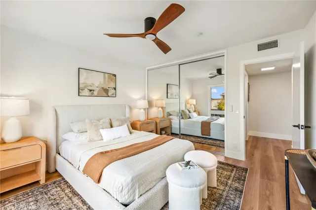 a bedroom with a bed and a large mirror