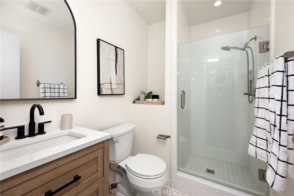1010 Palm Avenue, Unit 207 West Hollywood, CA 90069 - Photo 12 of 21 a bathroom with a toilet a sink and mirror