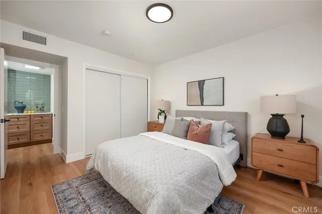 a bedroom with a bed and wooden floor