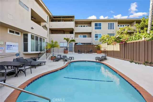 a view of a swimming pool with outdoor seating