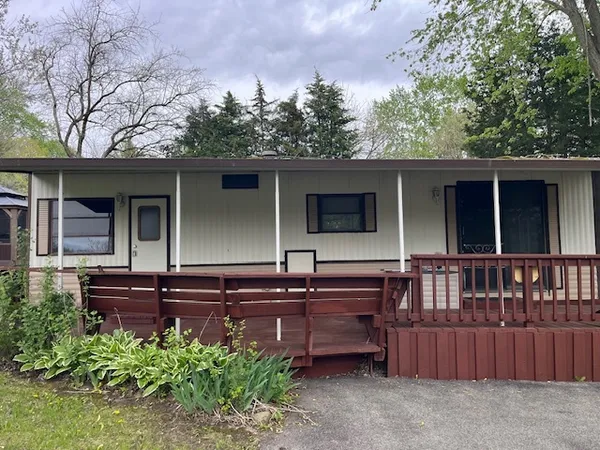 a view of house with outdoor space and deck